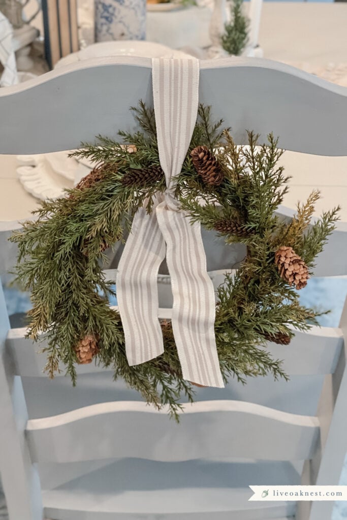 https://liveoaknest.com/wp-content/uploads/2021/12/French-Cottage-Wreath-On-Dining-Chair-Live-Oak-Nest-683x1024.jpg