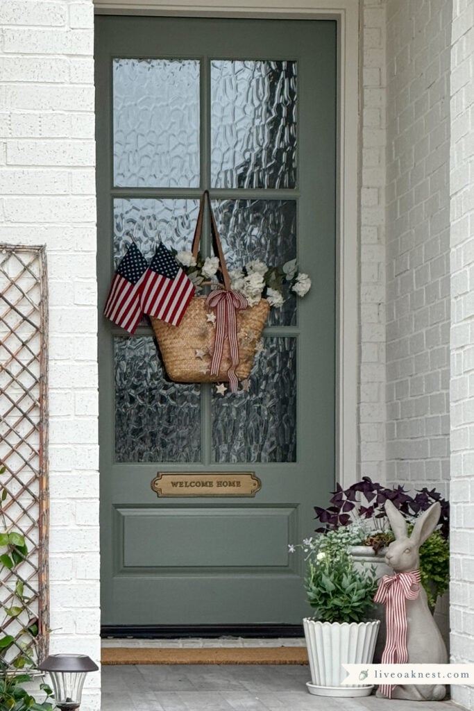 Patriotic Front Door Decor That Feels Cozy & Timeless, Basket of flowers on front door, Sage Green Painted Front Door from Live Oak Nest www.liveoaknest.com